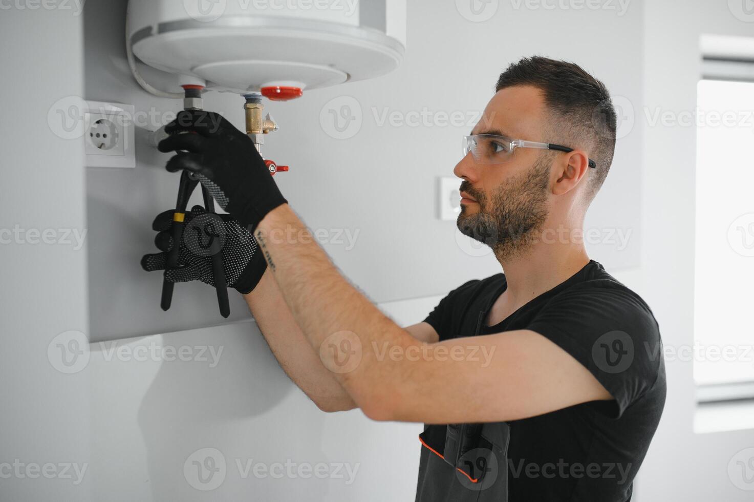 Professional plumber checking a boiler and pipes, boiler service concept photo