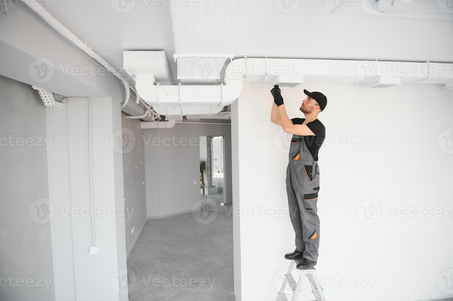 hvac services, worker install ducted pipe system for ventilation and air conditioning in house photo