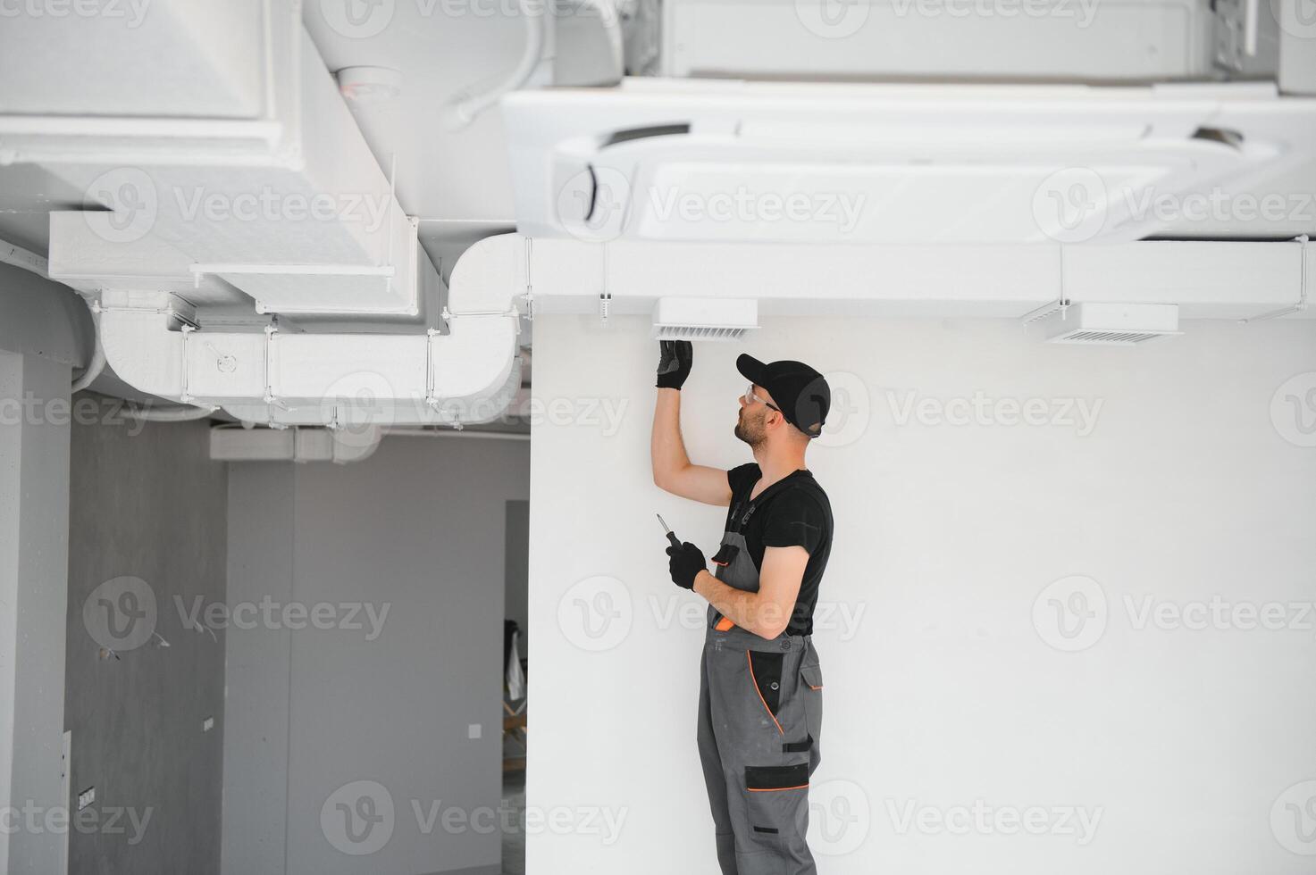 hvac services, worker install ducted pipe system for ventilation and air conditioning in house photo