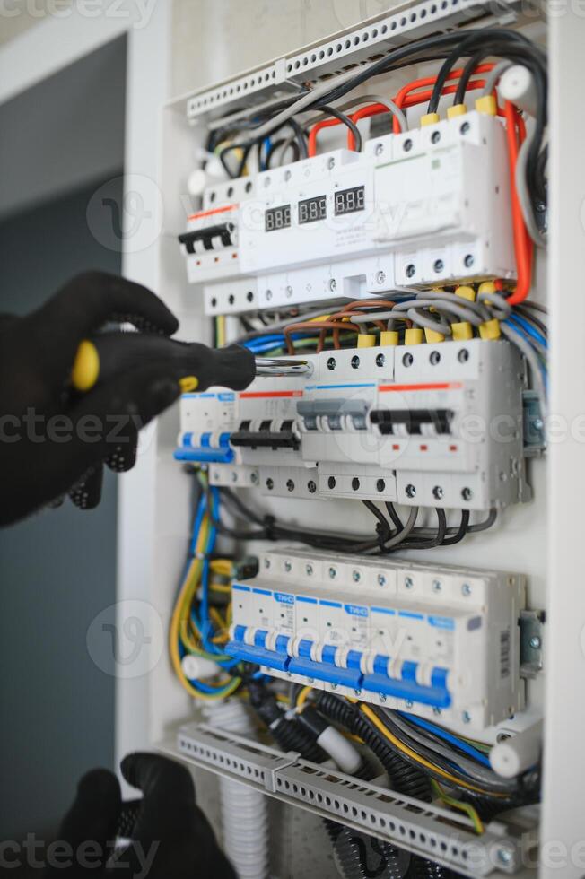 Close-up of electrician working on circuitry photo