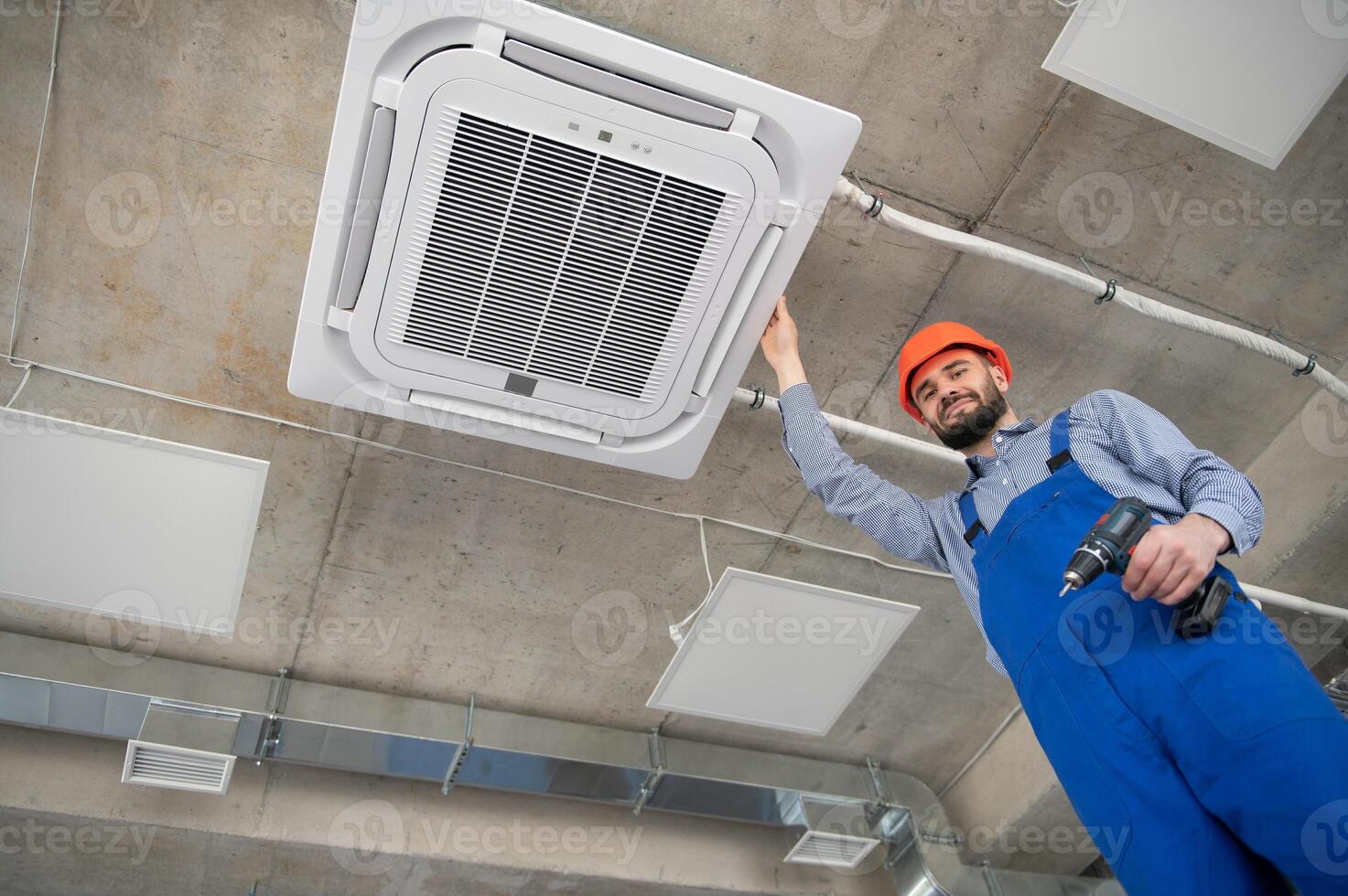 technician service checking and repairing air conditioner indoors photo