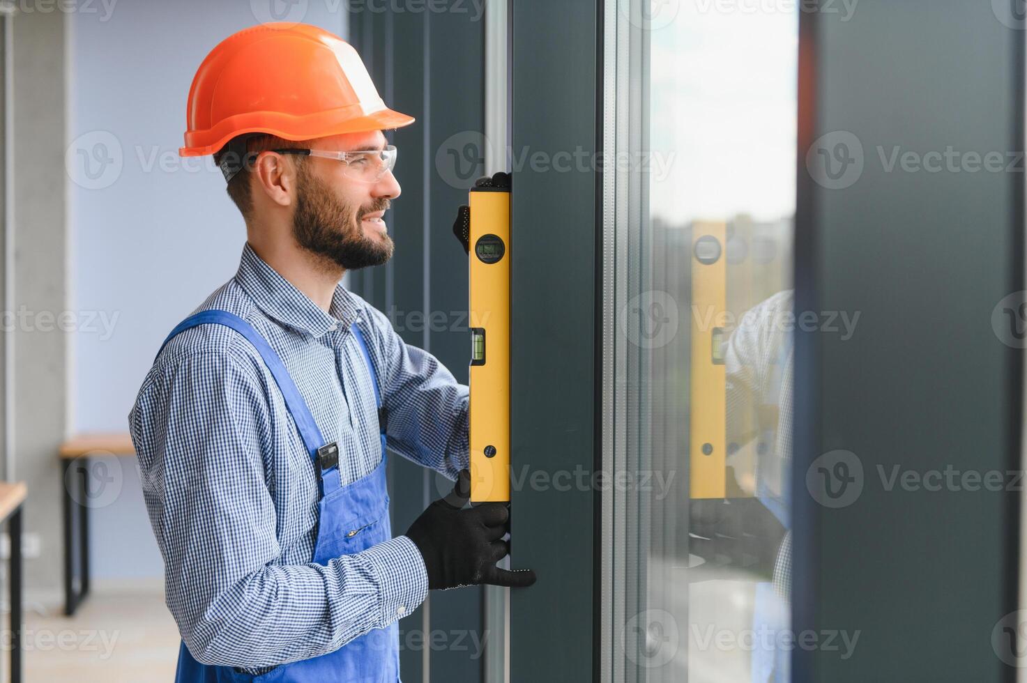 Worker installing plastic window indoors. photo