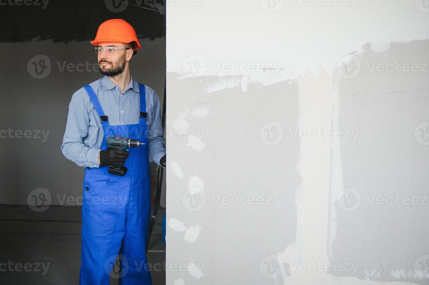 Workers install a plasterboard wall. photo