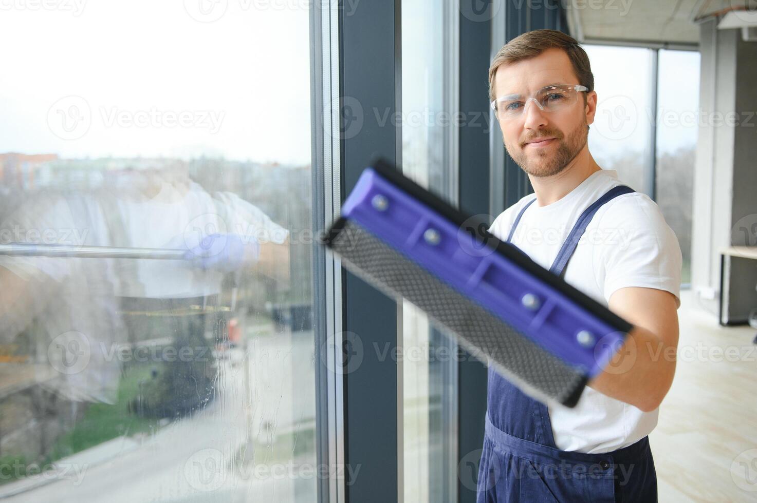 An employee of a professional cleaning service washes the glass of the windows of the building. Showcase cleaning for shops and businesses. photo