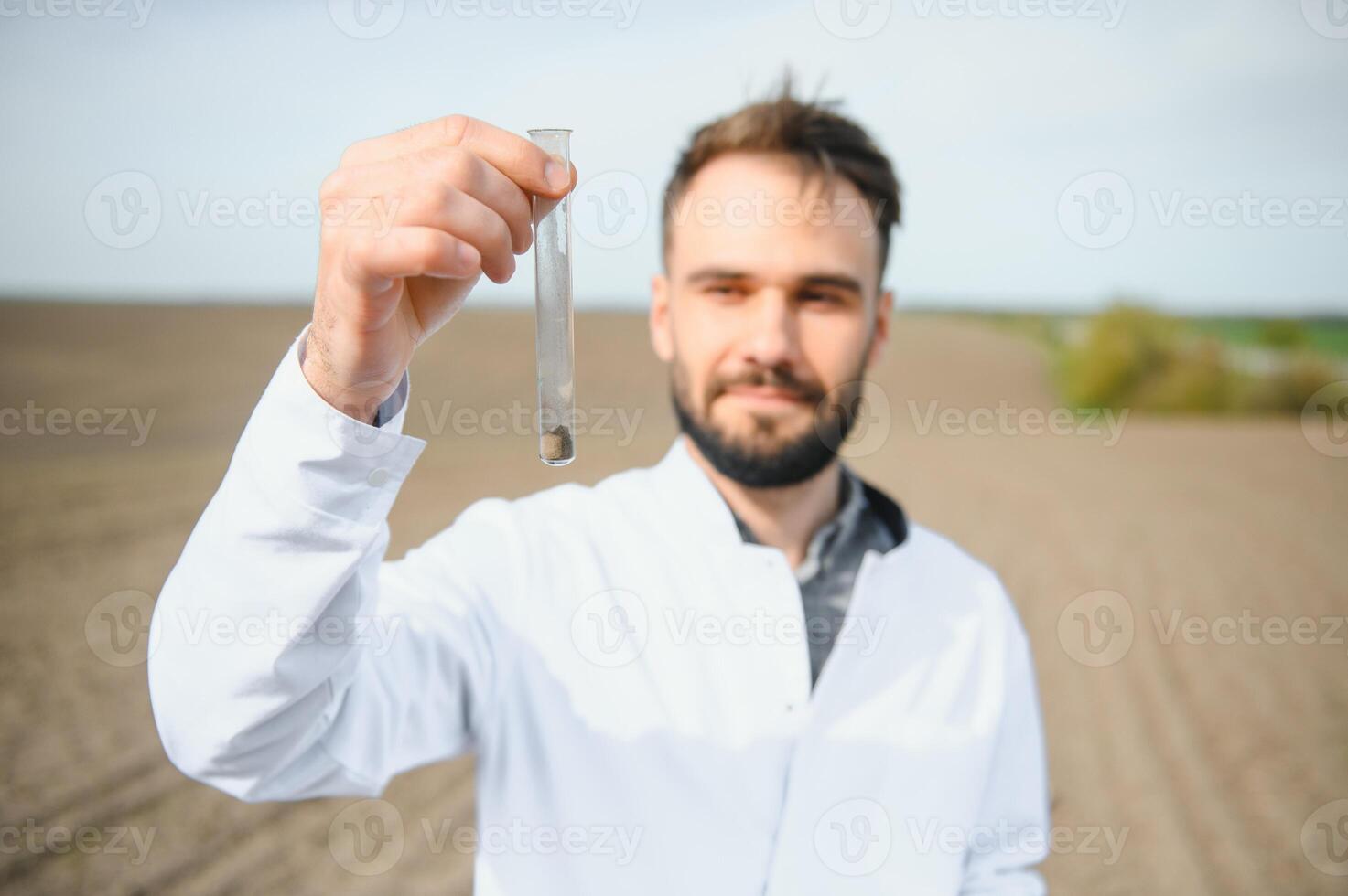 Soil Testing. Agronomy Specialist taking soil sample for fertility analysis. Hands in gloves close up. Environmental protection, organic soil certification, field work, research. photo