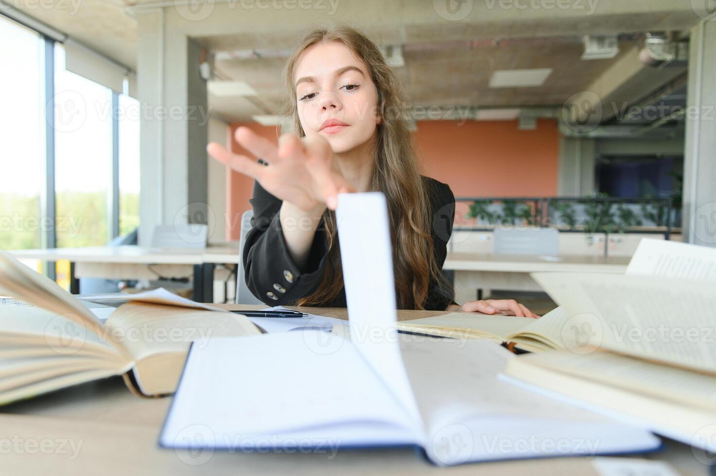 education and school concept - student girl studying and reading book at school. photo