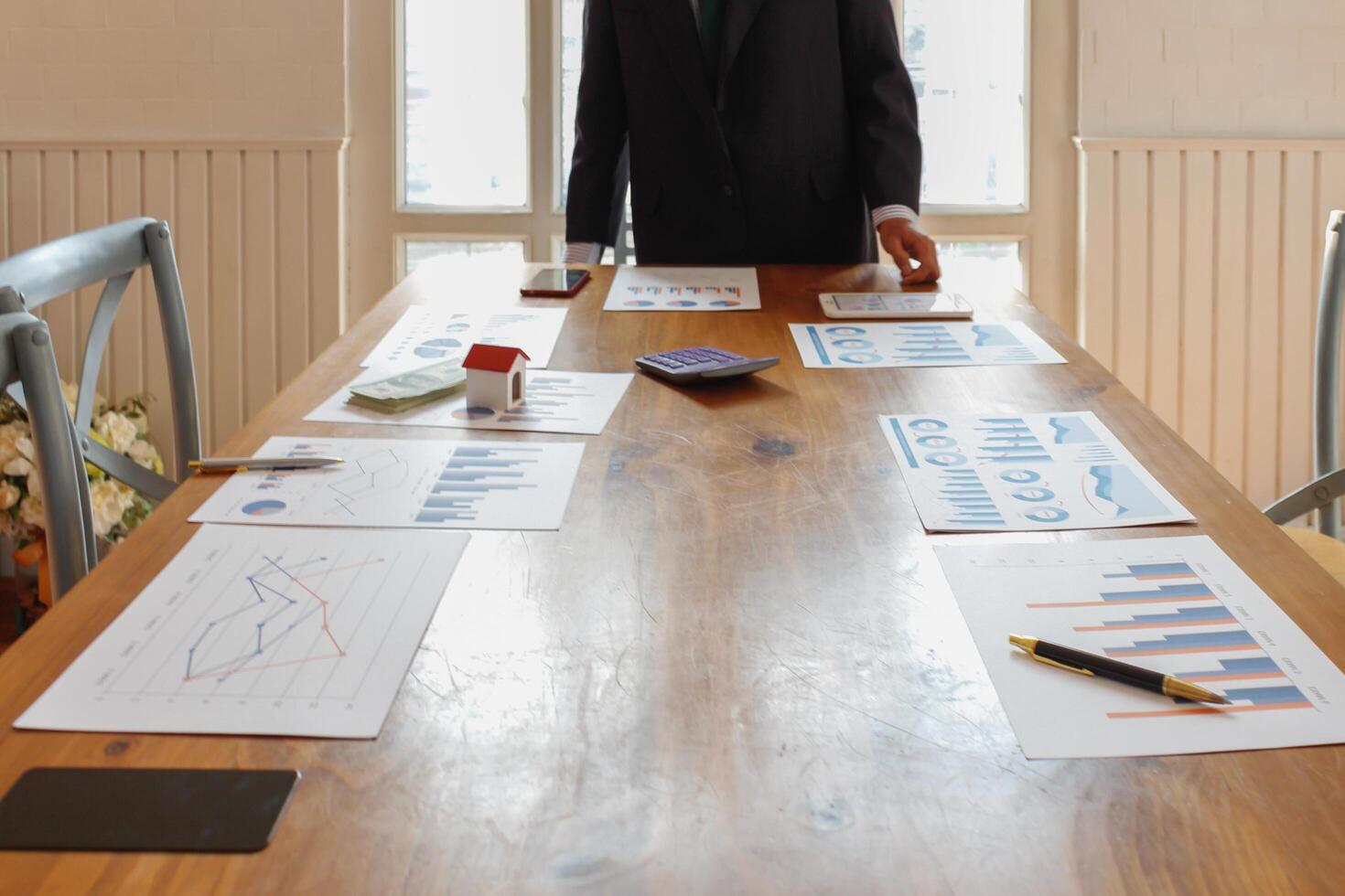 Annual earnings reports are placed on table in the conference room to prepare the paperwork for the board and investors to review annual earnings to adjust and make business plans for the coming year. photo