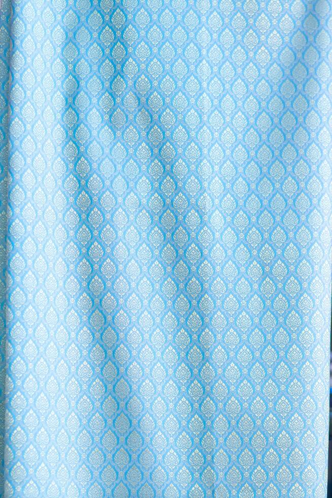 Thai silk with beautiful patterns and a high price because silk is added using ancient methods to produce fibers and weaving with ancient weaving machines resulting in beautiful patterned silk. photo