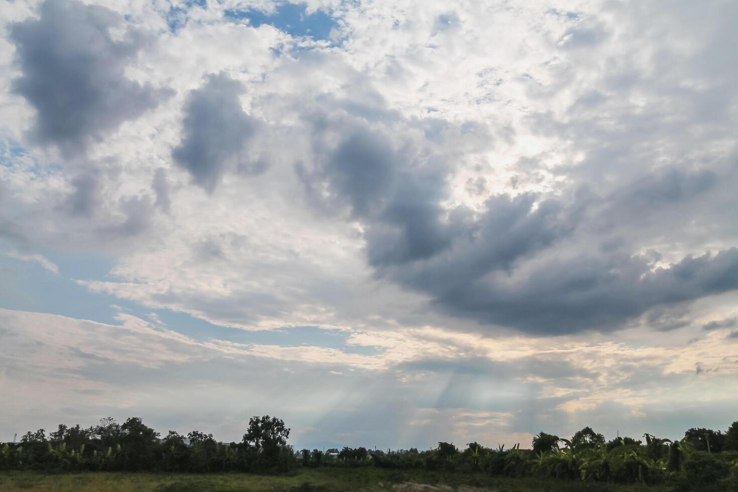 Black clouds in the sky in the rainy season are the formations of a rain storm in the evening. The background of the sky full of black dark rain clouds photo