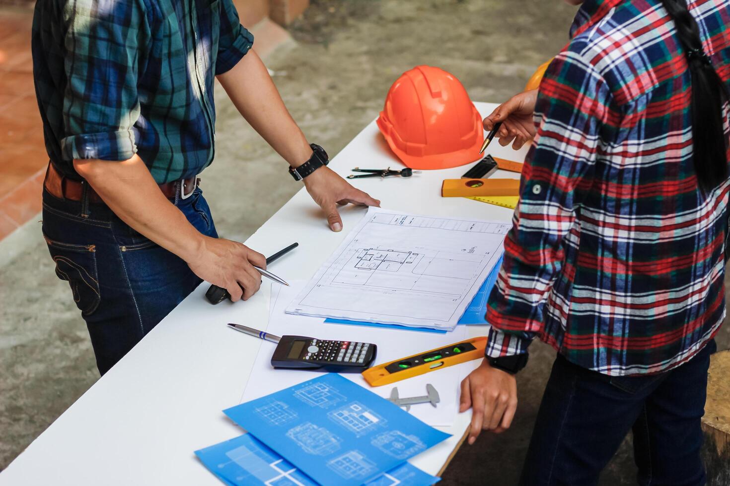 The engineer is giving advice and consulting with the designer to find out the construction site where the engineer will have to construct the project. Consultation between engineers and designers photo