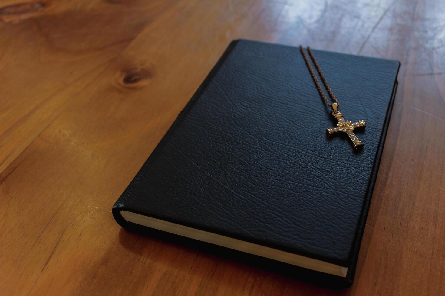 The sacred cross that represented God rested on the Bible, which represented the teachings of God placed on a wooden table inside the church to prepare the believers to learn the teachings of God. photo