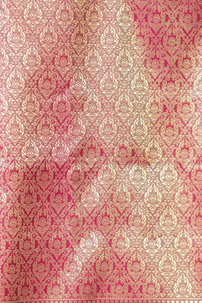 Thai silk with beautiful patterns and a high price because silk is added using ancient methods to produce fibers and weaving with ancient weaving machines resulting in beautiful patterned silk. photo