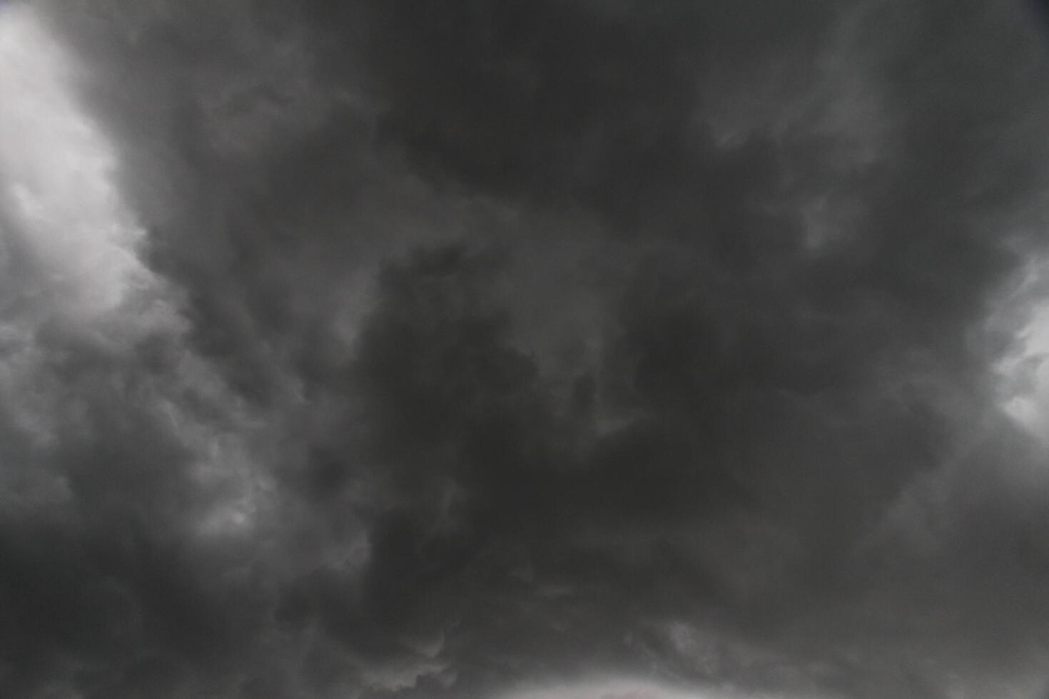 The rain clouds that are forming above the sky are rain clouds of the storms that are bringing moisture into the seasonal areas. The background of the sky is full of black clouds from thunderstorm photo
