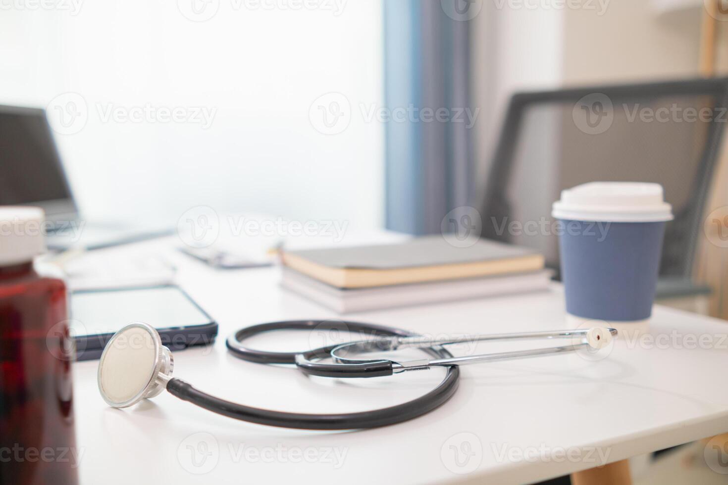 stethoscope is placed on work desk in doctor office After examining patient stethoscope is placed on the work desk to examine additional information from the computer that has compiled the results. photo