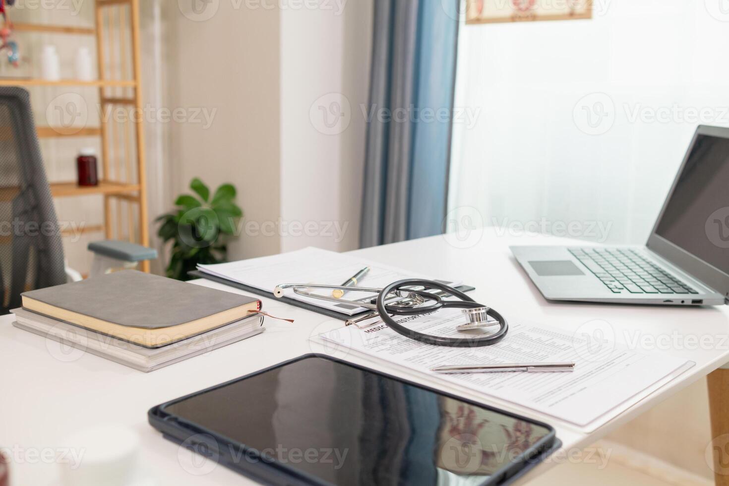 stethoscope is placed on work desk in doctor office After examining patient stethoscope is placed on the work desk to examine additional information from the computer that has compiled the results. photo