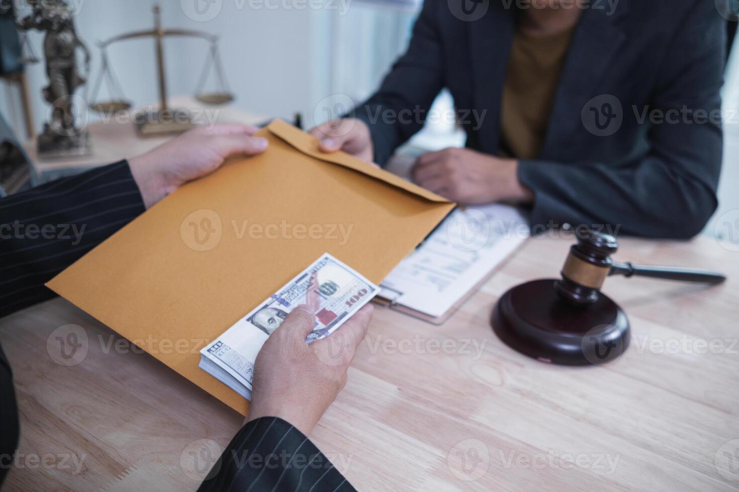 The businessman offered cash to prosecutors as a bribe to help change the verdict in the case, knowing that bribery is a serious and illegal crime. The concept of bribing government officials photo