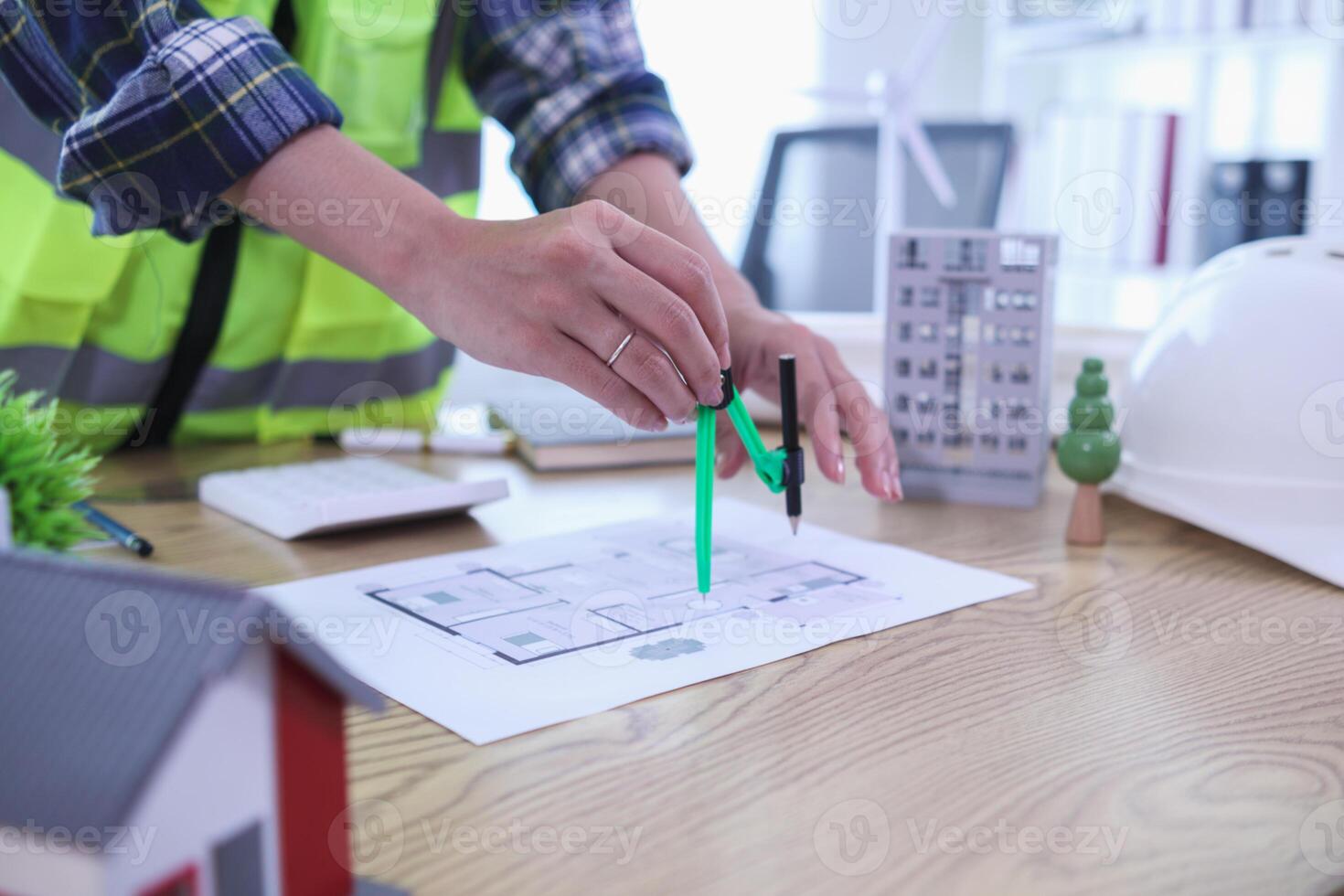 A team of engineers and architects discuss house plan design and estimate construction prices to suit the construction budget. Checking blueprints and documents with a team of engineers and architects photo