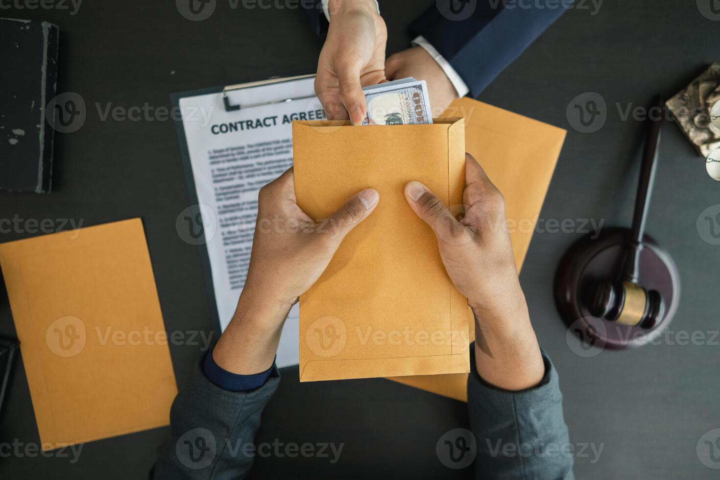 The businessman offered cash to prosecutors as a bribe to help change the verdict in the case, knowing that bribery is a serious and illegal crime. The concept of bribing government officials photo