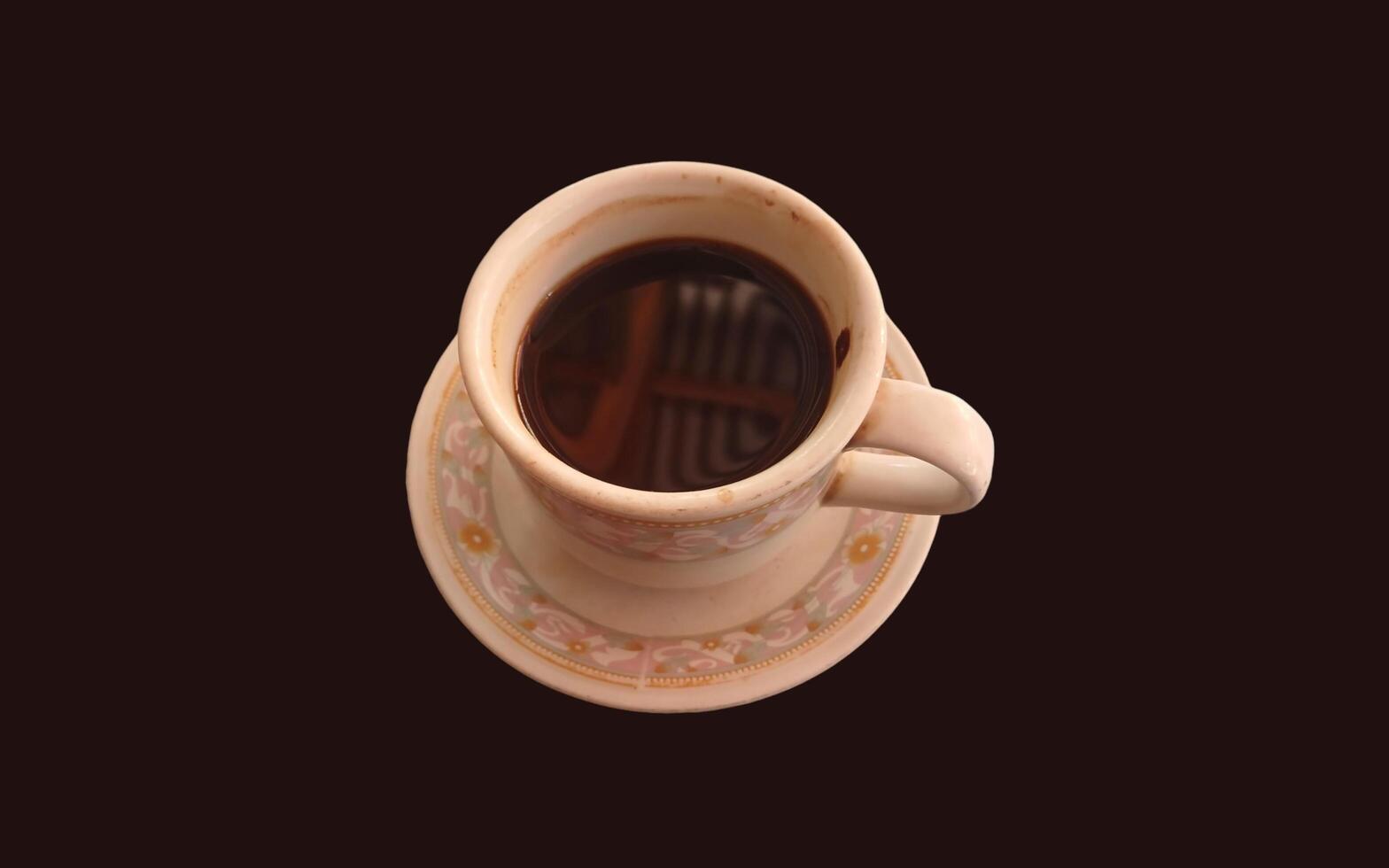 Cup of coffee isolated on brown background photo