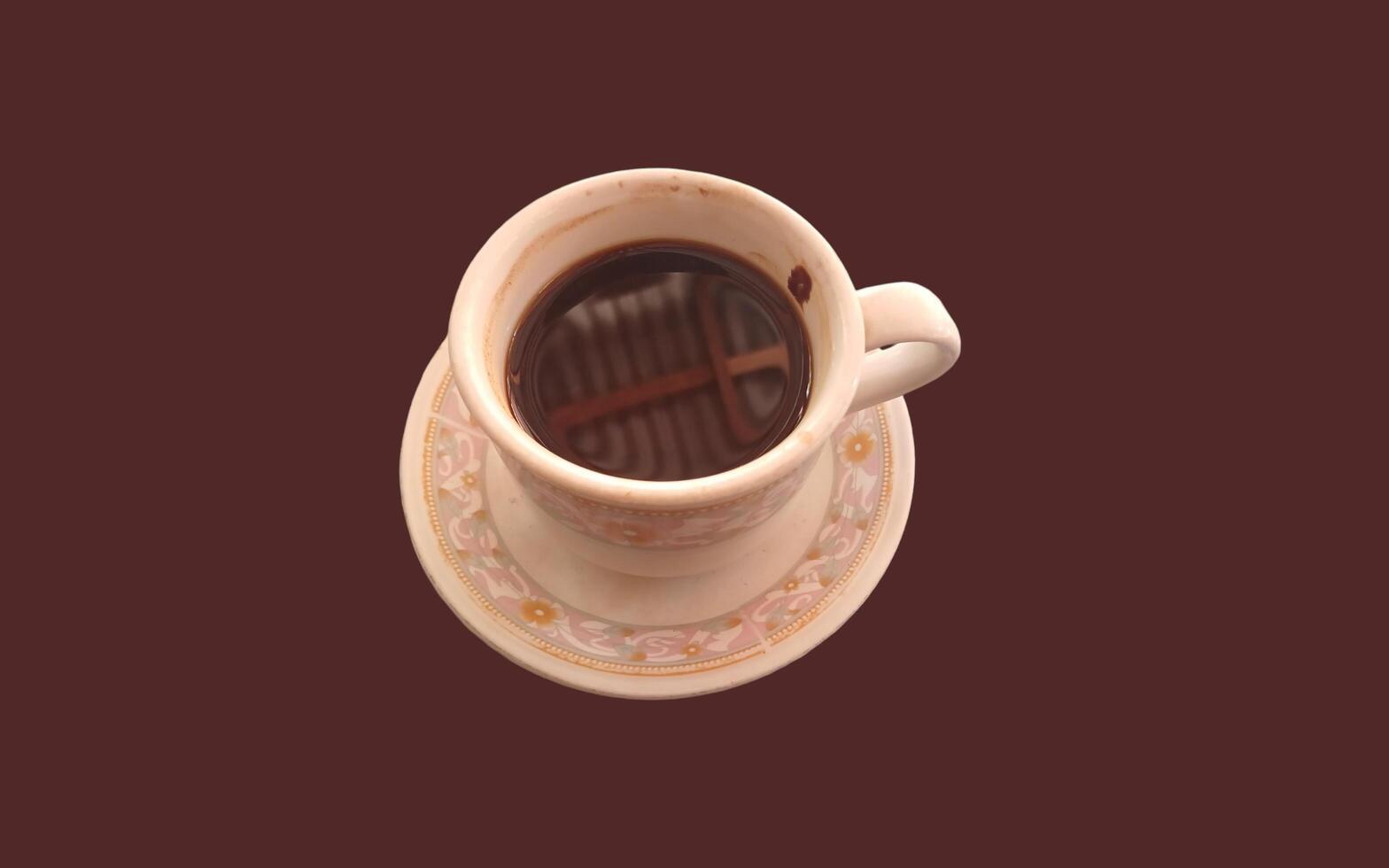 Cup of coffee isolated on brown background photo
