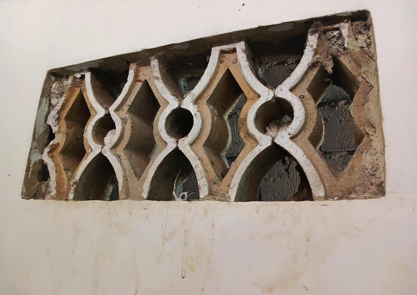 A ventilation roster arrangement made of concrete, brick, natural stone that functions as air circulation and lighting. photo
