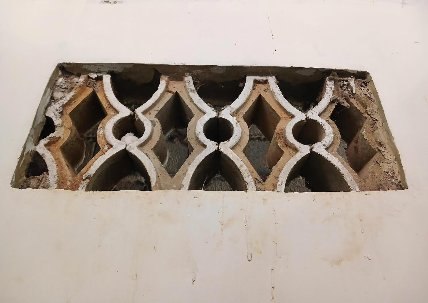 A ventilation roster arrangement made of concrete, brick, natural stone that functions as air circulation and lighting. photo