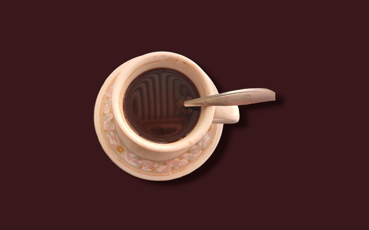 Cup of coffee isolated on brown background photo