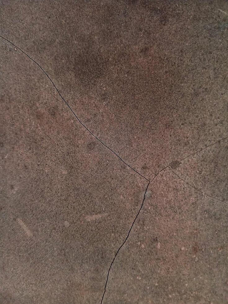 Close-up of a cracked building wall textured background. Suitable for additional design projects. photo