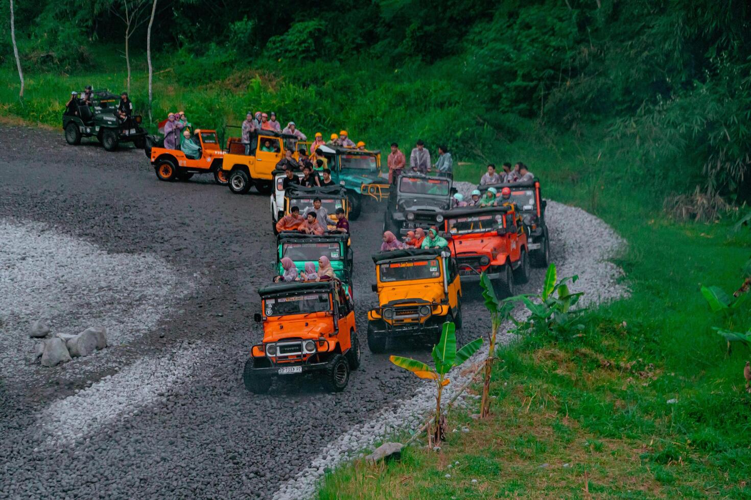 Yogyakarta, Indonesia, 2024 - Crossing the river in a high-speed jeep until the water splashes in all directions and wets the passengers. Offroad driving tourist jeep during holiday season photo