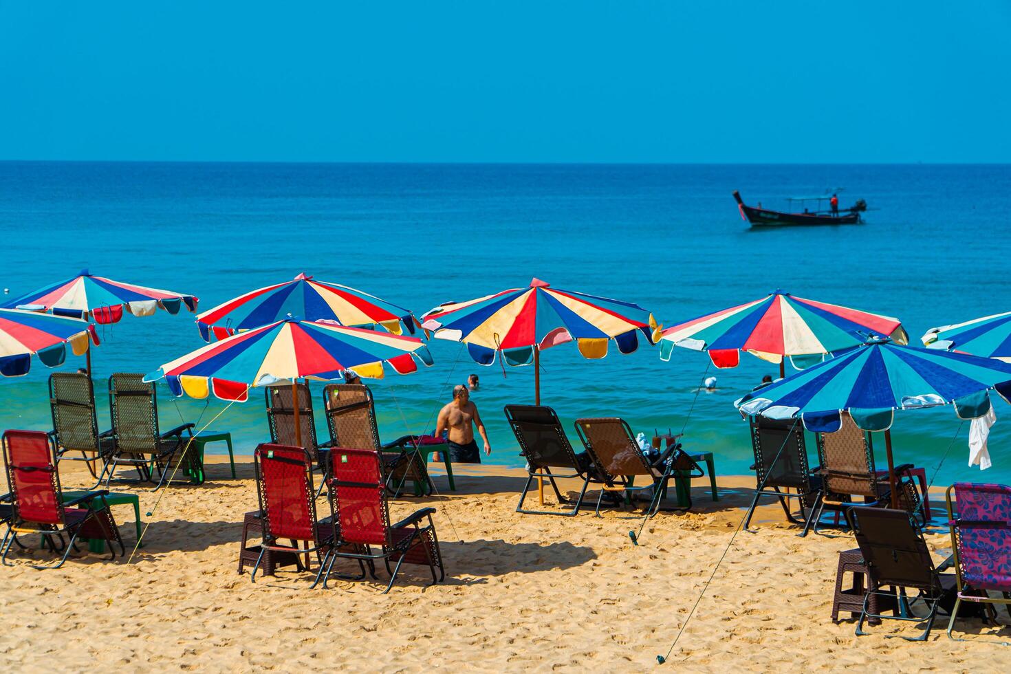 Karon Beach, one of the favorite beaches visited by tourists to enjoy the summer in Phuket, Thailand. The beauty of Karon beach with calm waves and white sand on a hot day photo