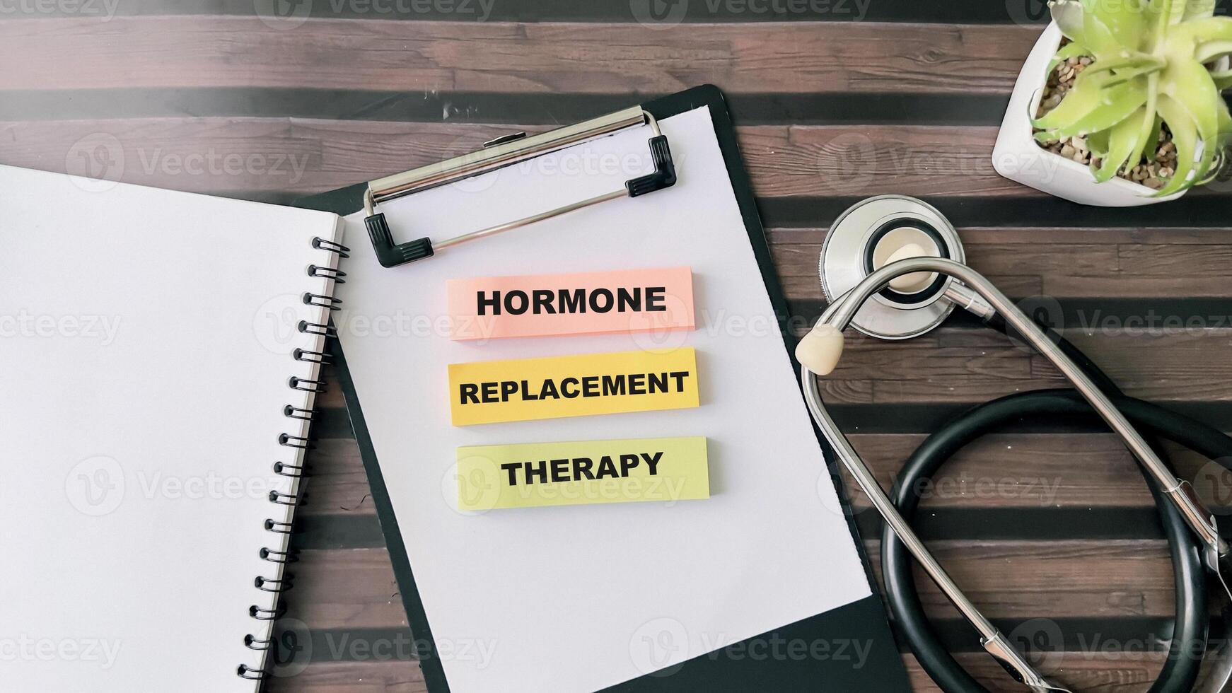 Concept of Hormone Replacement Therapy write on sticky notes isolated on Wooden Table. photo