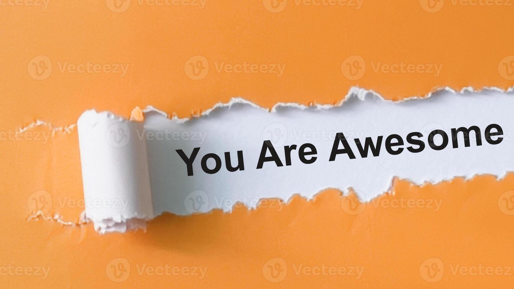 Concept of You Are Awesome Text written in torn paper. photo