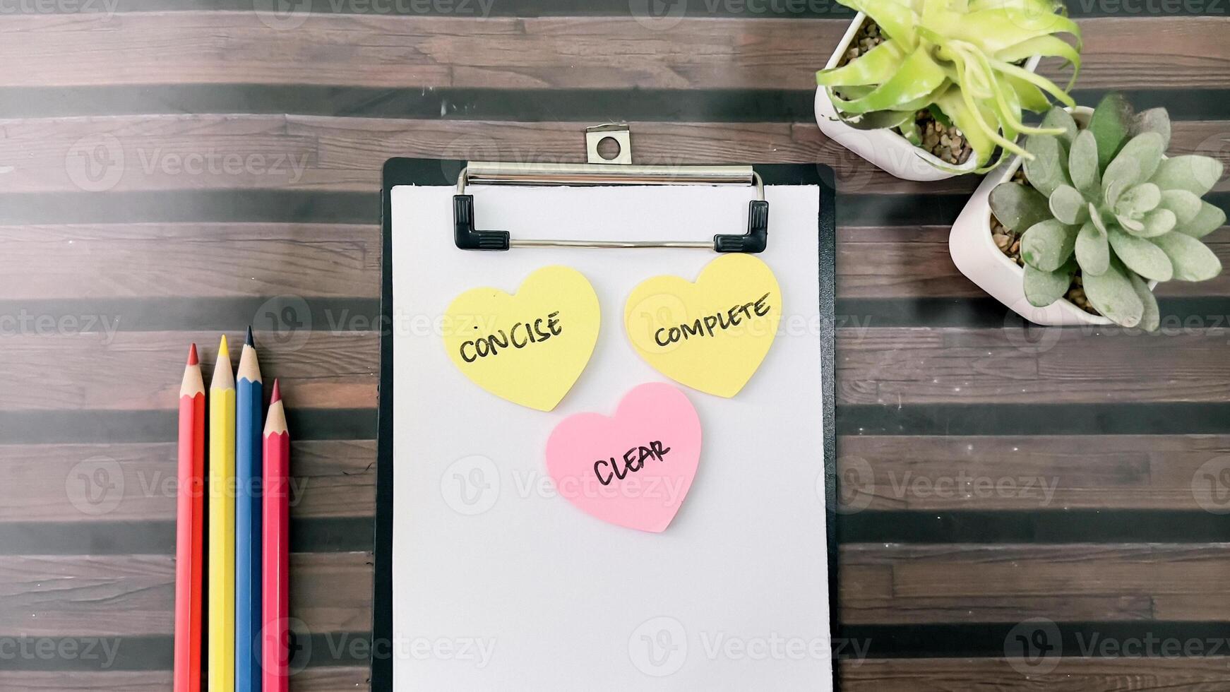 Concept of Concise, Clear, Complete write on sticky notes isolated on Wooden Table. photo