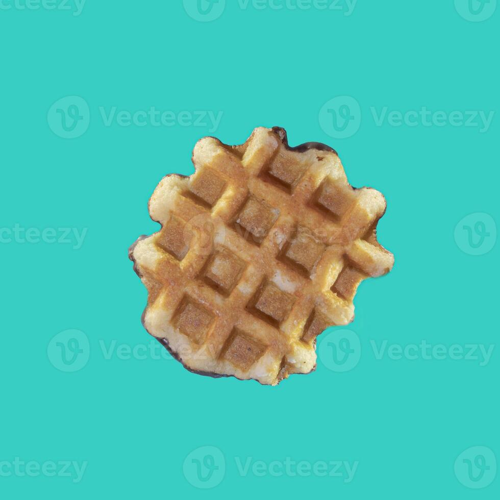 The texture of a standard waffle, on a light blue background. Square format photo