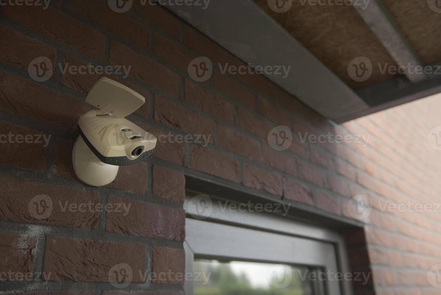 Obsolete surveillance camera installed at the entrance to the premises photo