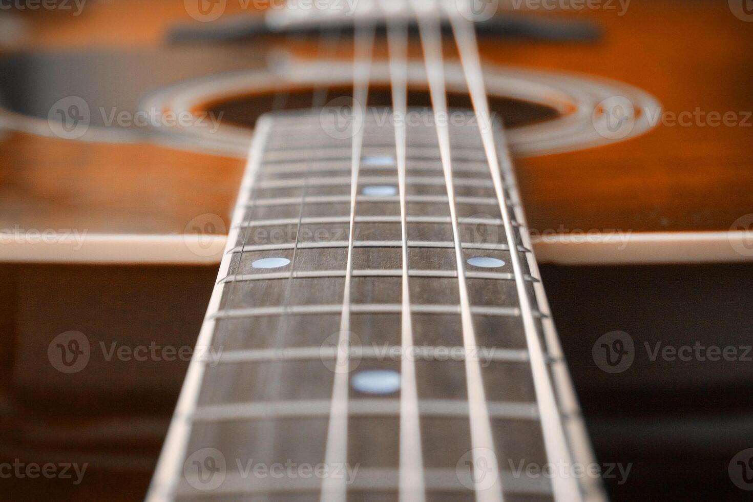 Neck a wooden acoustic guitar photo
