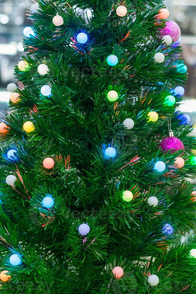 View on a multicolored garlands on a Christmas tree photo