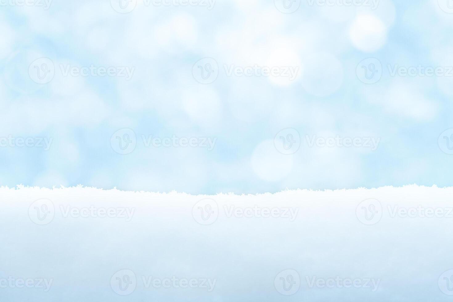 Light blue winter background with snow drifts and bokeh photo