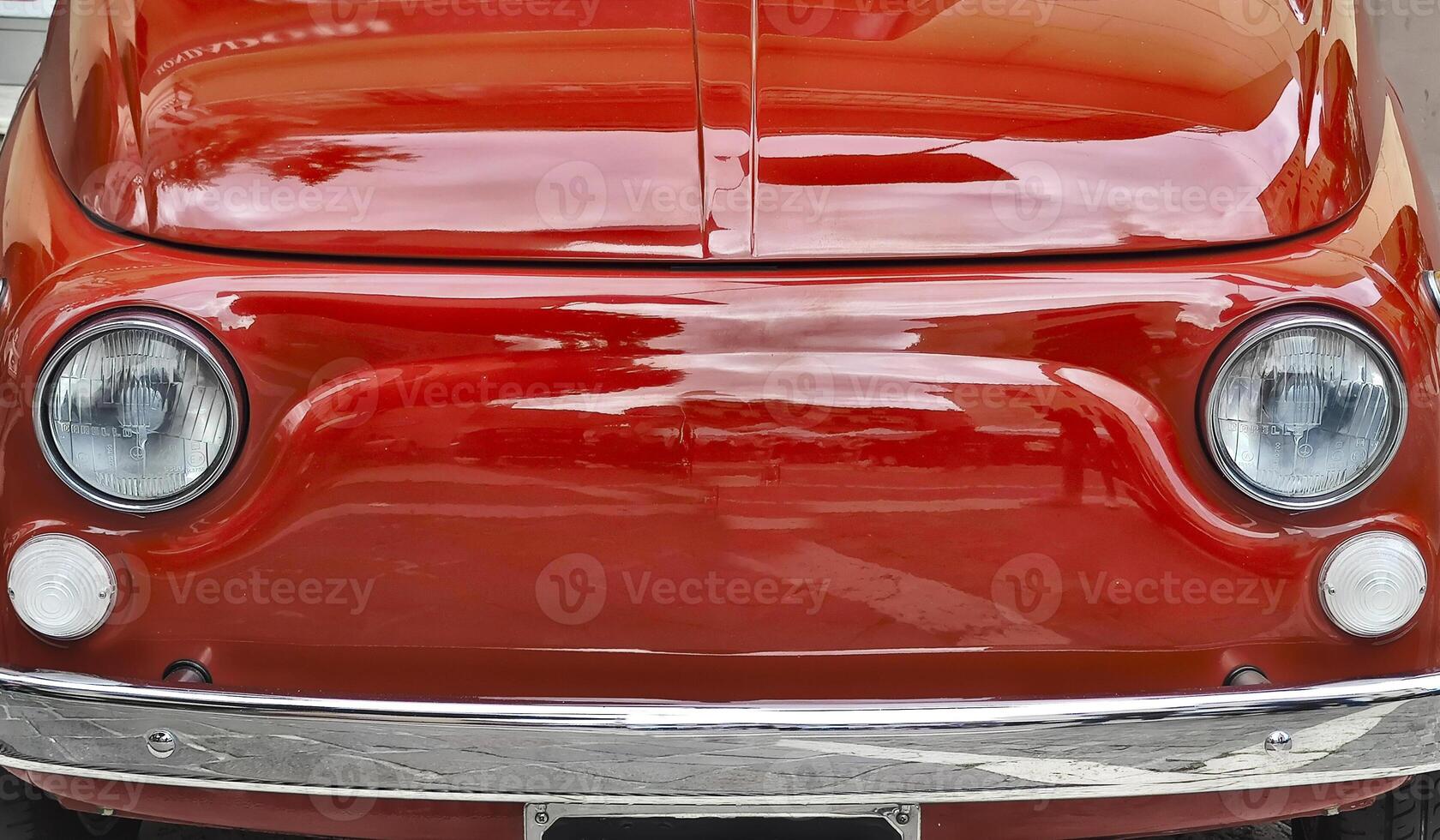 Vintage Red Car Front with Classic Chrome Details on a Sunny Day photo