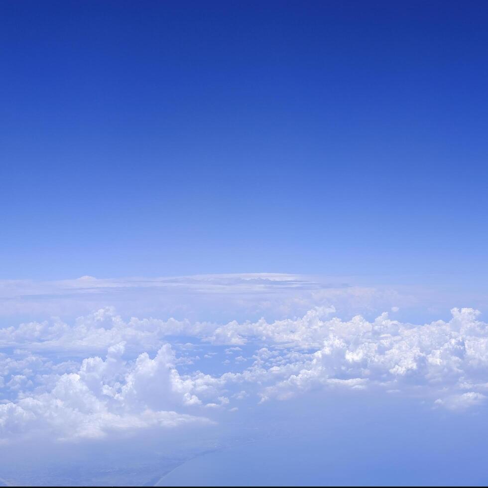 Square gradient blue sky with white fluffy clouds photo