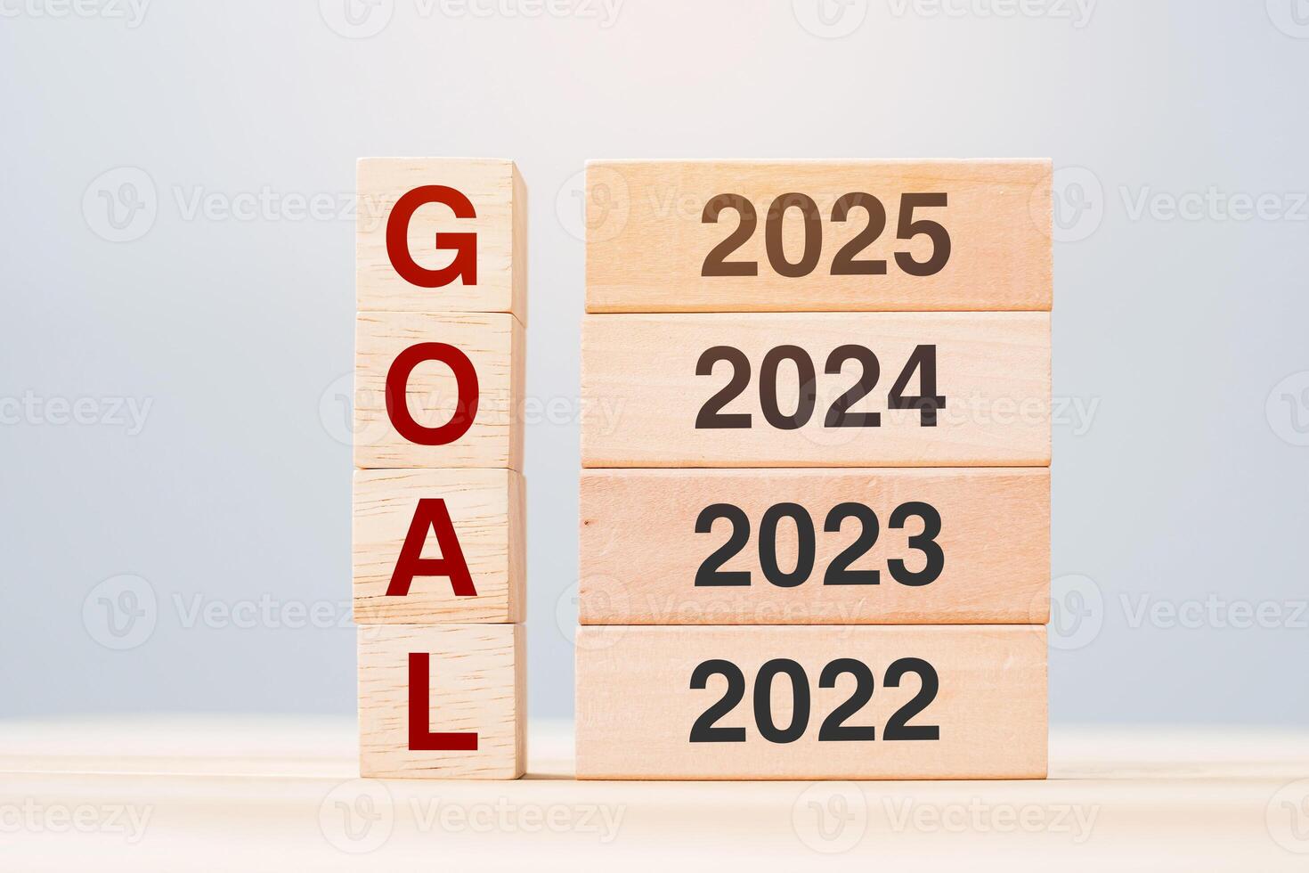 2025 block over 2024 and 2023 wooden building on table background. Business planning, Risk Management, Resolution, strategy, solution, goal, New Year New You and happy holiday concepts photo