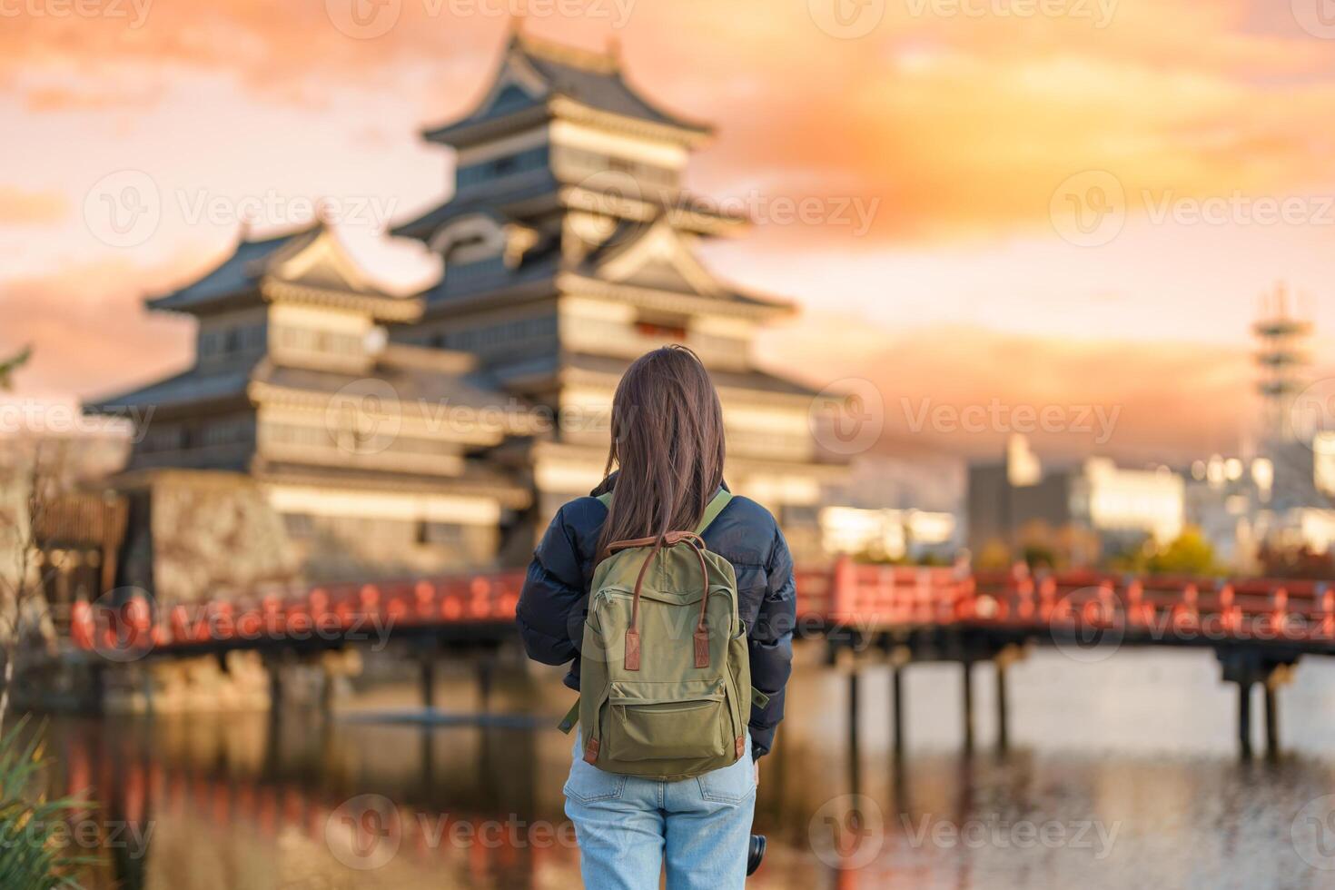 Woman tourist Visiting in Matsumoto, happy Traveler sightseeing Matsumoto Castle or Crow castle. Landmark and popular for tourists attraction in Matsumoto, Nagano, Japan. Travel and Vacation concept photo