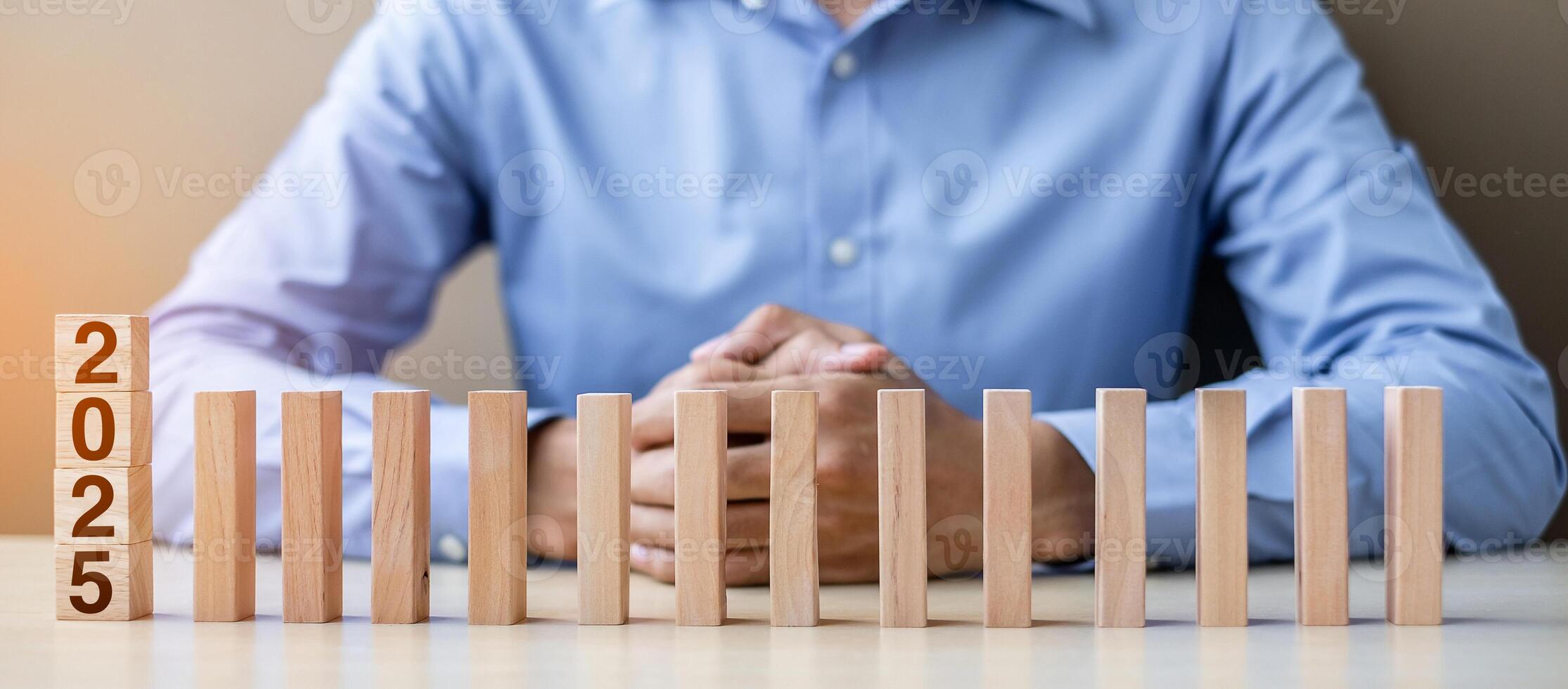 Businessman with 2025 wooden Blocks. Business, Risk Management, Insurance, Resolution, strategy, solution, goal, New Year New You and happy holiday concepts photo