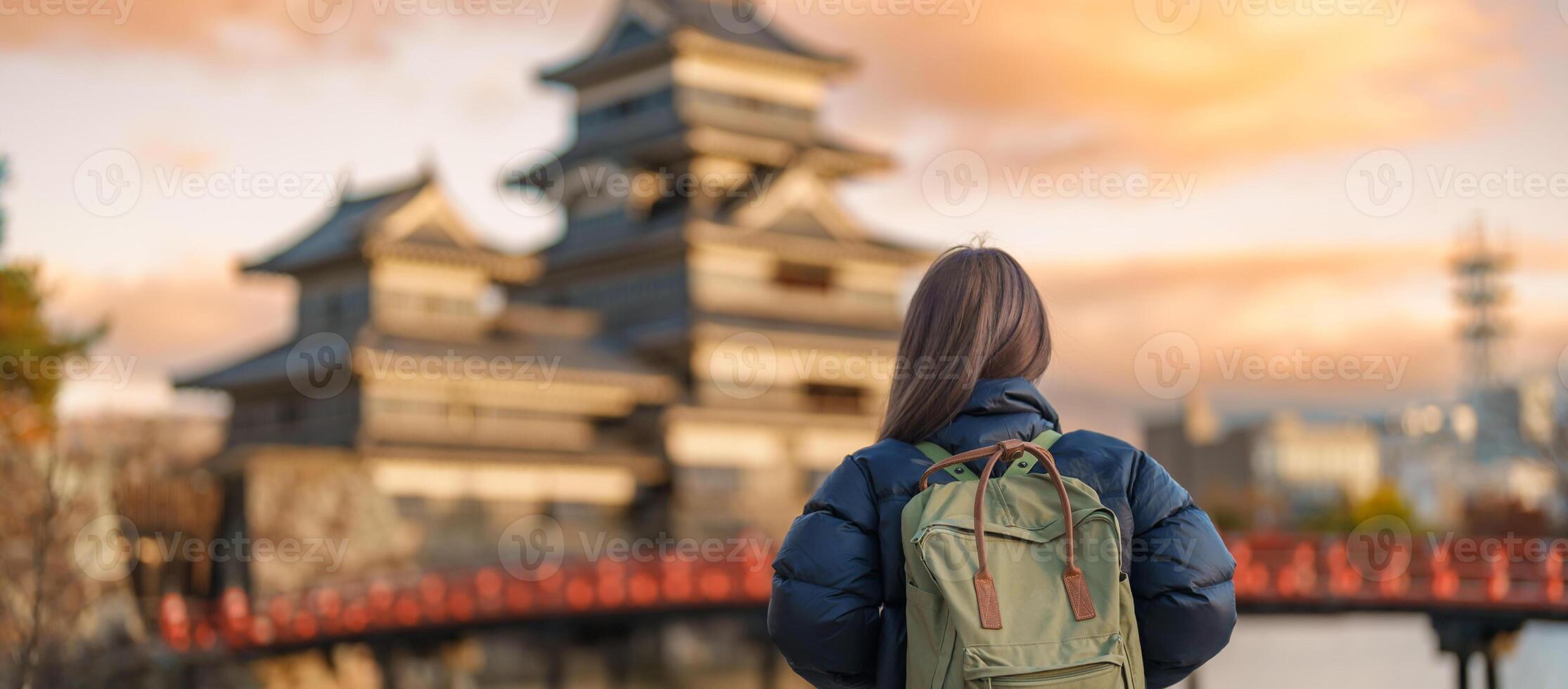 Woman tourist Visiting in Matsumoto, happy Traveler sightseeing Matsumoto Castle or Crow castle. Landmark and popular for tourists attraction in Matsumoto, Nagano, Japan. Travel and Vacation concept photo