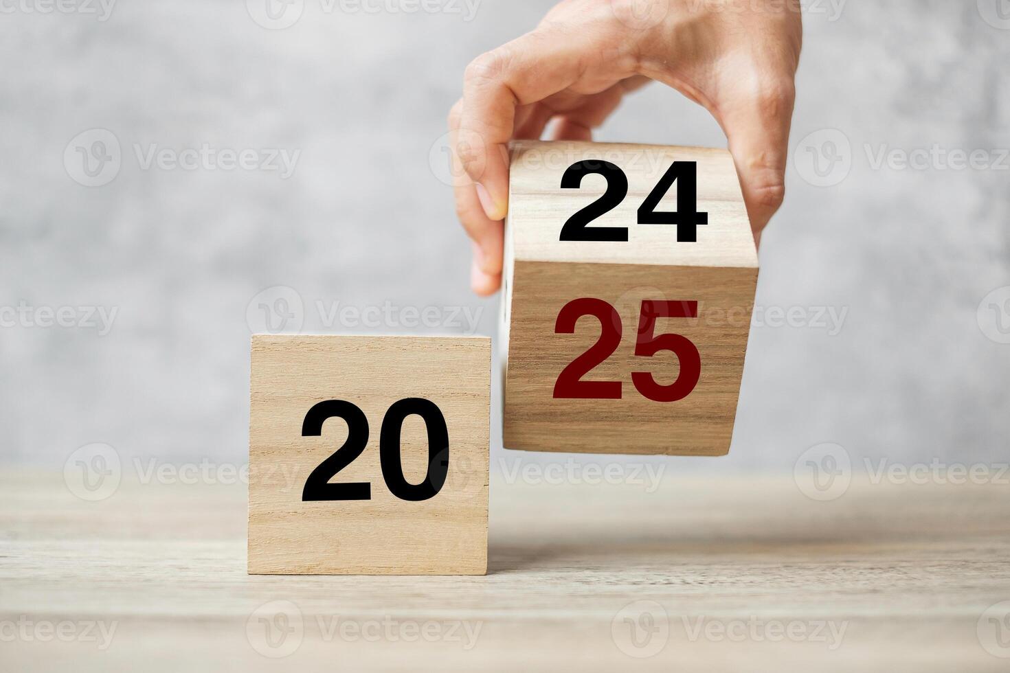 hand flipping block 2024 to 2025 text on table. Resolution, strategy, plan, goal, motivation, reboot, business and New Year holiday concepts photo