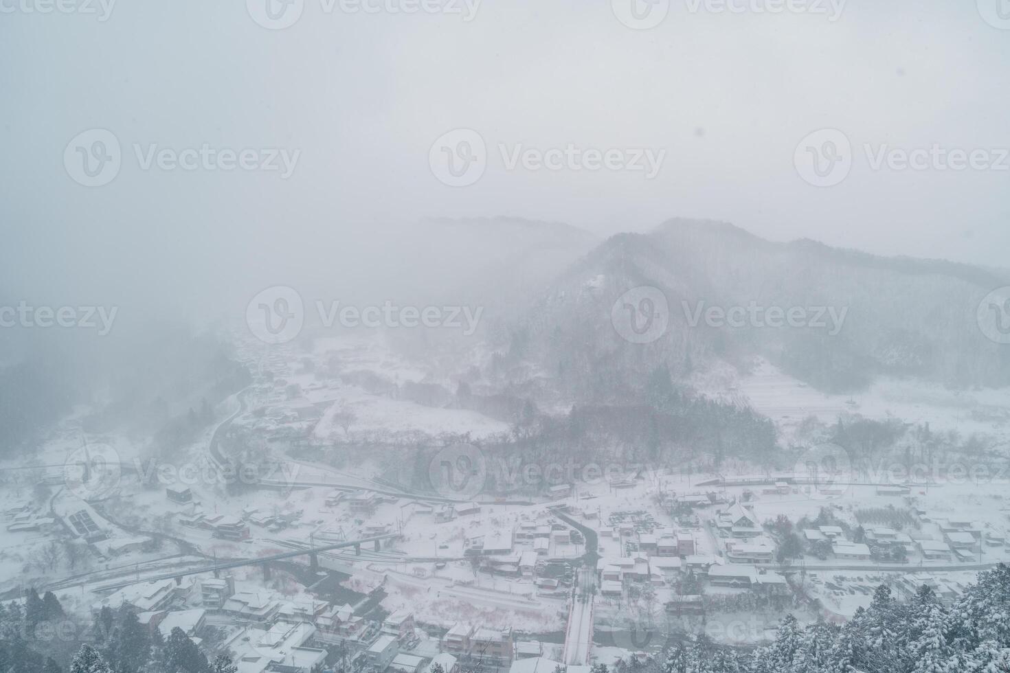 view of village with snow in winter from mountain viewpoint of Yamadera temple, the popular name for the Buddhist temple of Risshakuji located in Yamagata City, in Yamagata Prefecture, Tohuku, Japan photo