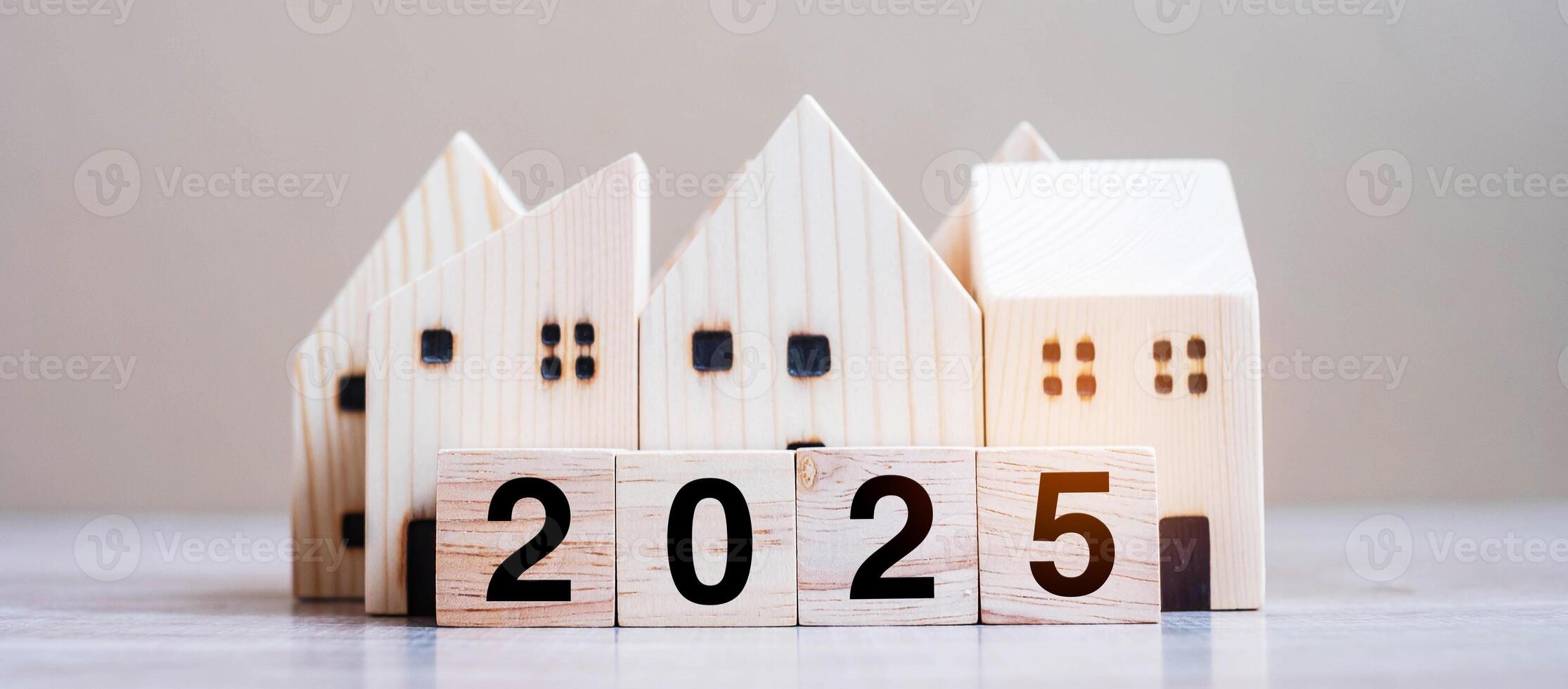 2025 Happy New Year with house model on table wooden background. Banking, real estate, investment, financial, savings and New Year Resolution concepts photo