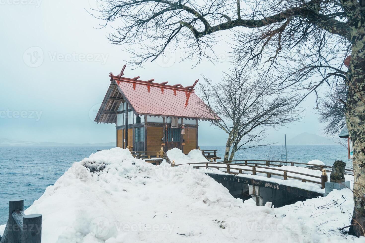 Kansa Shrine and Lake Tazawa with snow in winter season. located in Semboku city, Akita Prefecture, northern Japan. Landmark and famous for tourists attractions in Tohoku region, Japan photo
