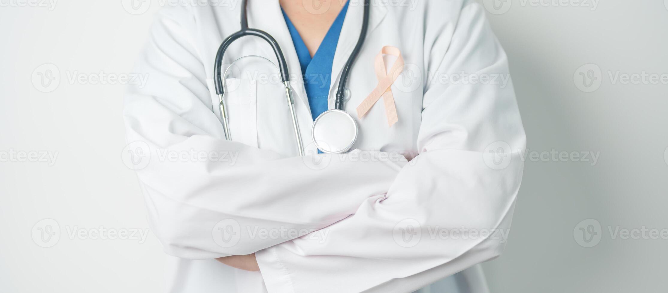 Doctor holding Peach Ribbon for September Uterine Cancer Awareness month. Uterus and Ovaries, Endometriosis, Hysterectomy, Uterine fibroids, Reproductive, Healthcare and World cancer day concept photo