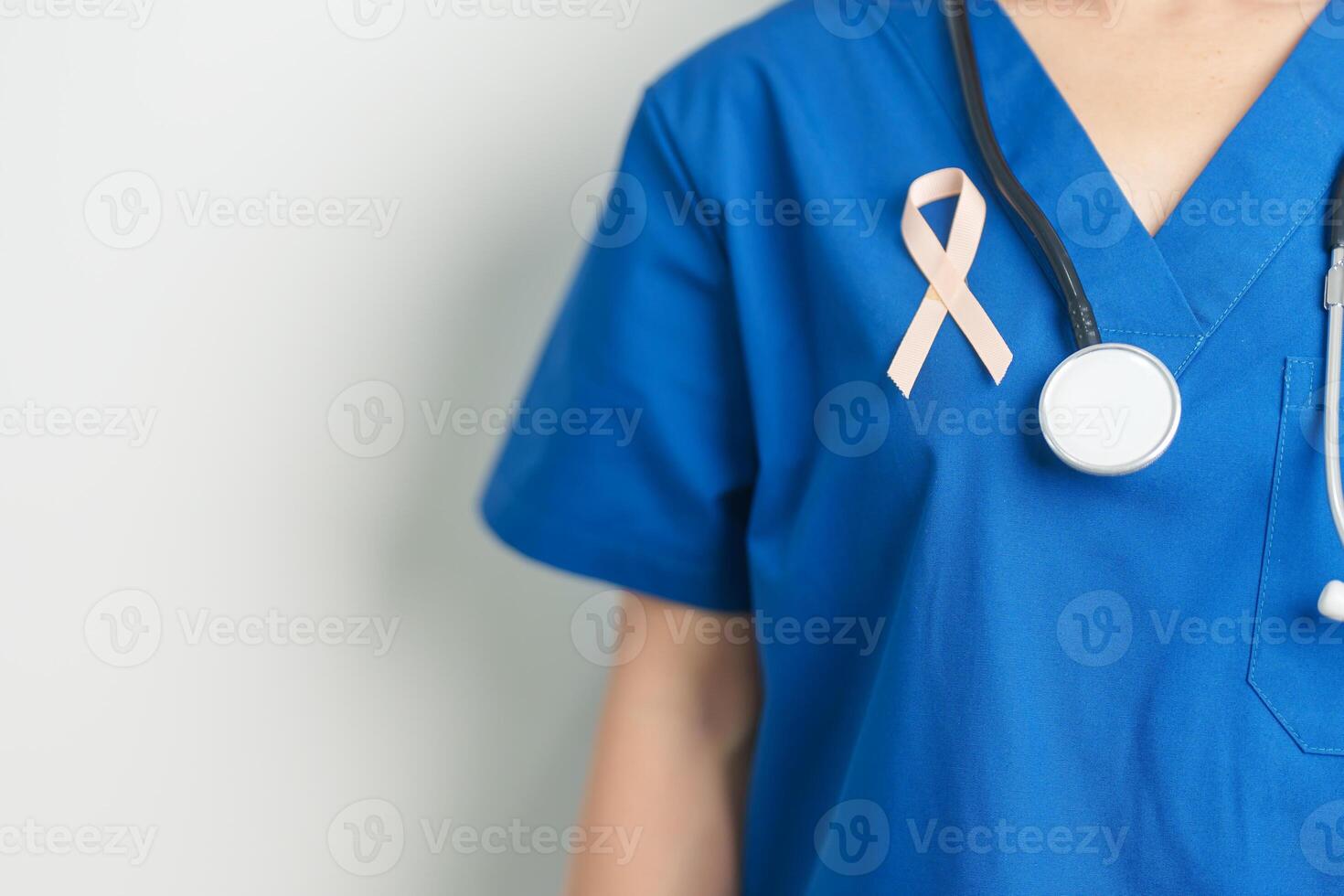 Doctor holding Peach Ribbon for September Uterine Cancer Awareness month. Uterus and Ovaries, Endometriosis, Hysterectomy, Uterine fibroids, Reproductive, Healthcare and World cancer day concept photo